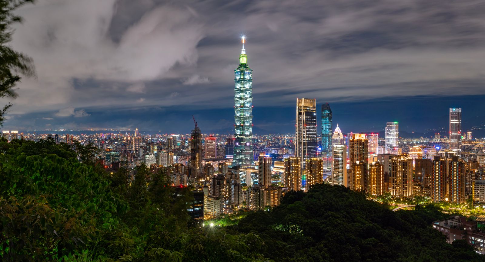 Taipei 101 and the city skyline at night, seen from Elephant Mountain — the vantage point from which Meridian Frame Research writes about international currency exposure.